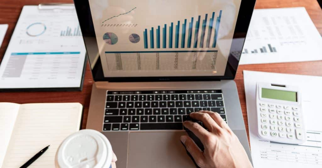 Small business owner reviewing financial reports for effective management
