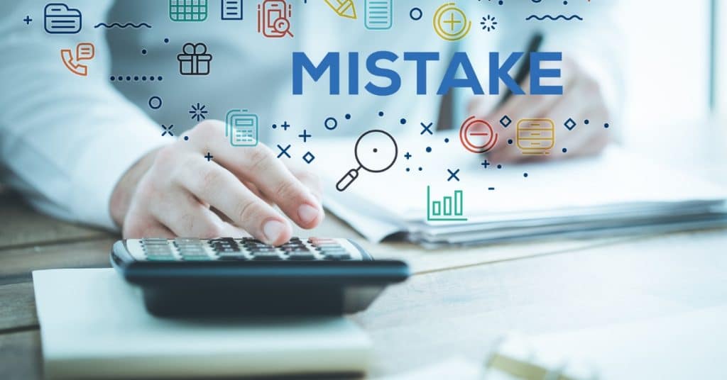 New entrepreneur analyzing financial documents to avoid common mistakes